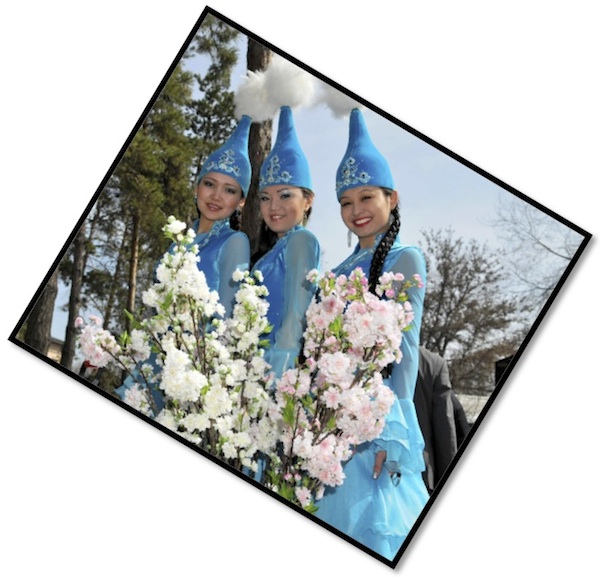 Three women in traditional Kasakhstan costumes.