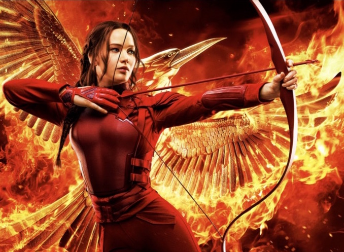 Katniss with bow and arrow transforms to Mockingjay at Movies Grow English.  Movie-based ESL lessons